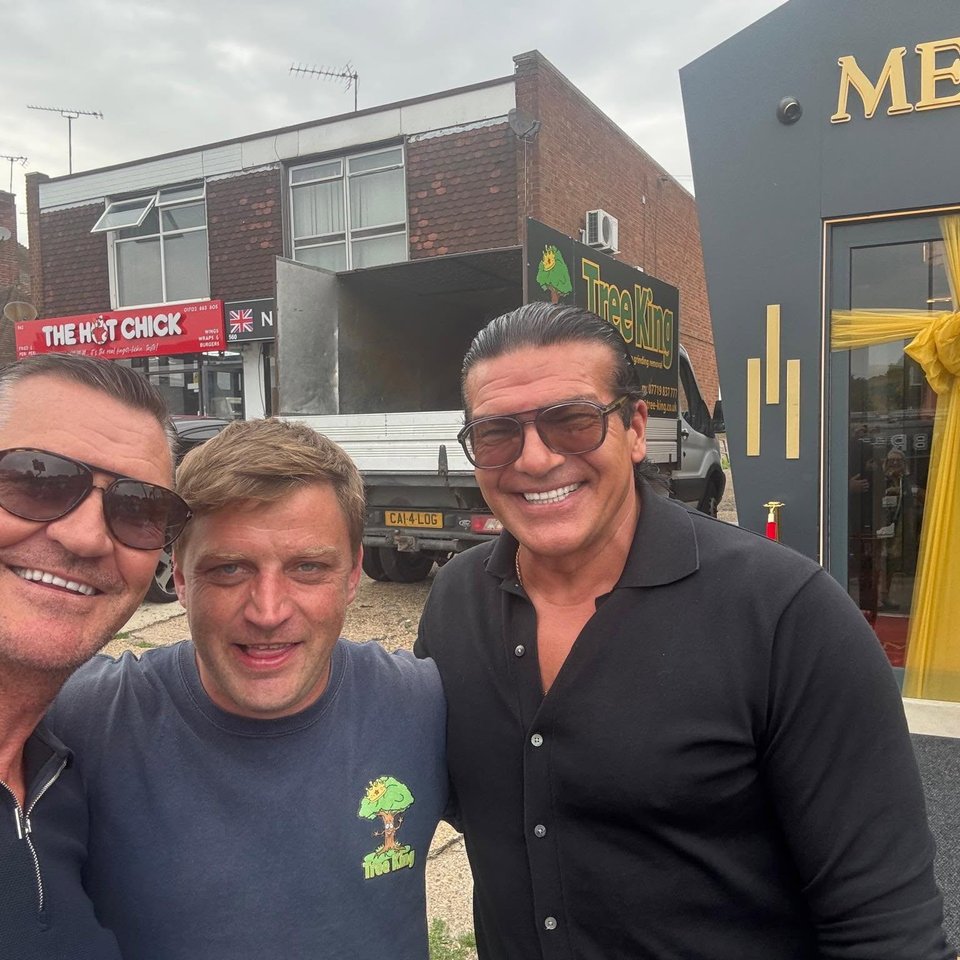 Mitch King of Tree King (centre) with guests, in front of the Tree King truck